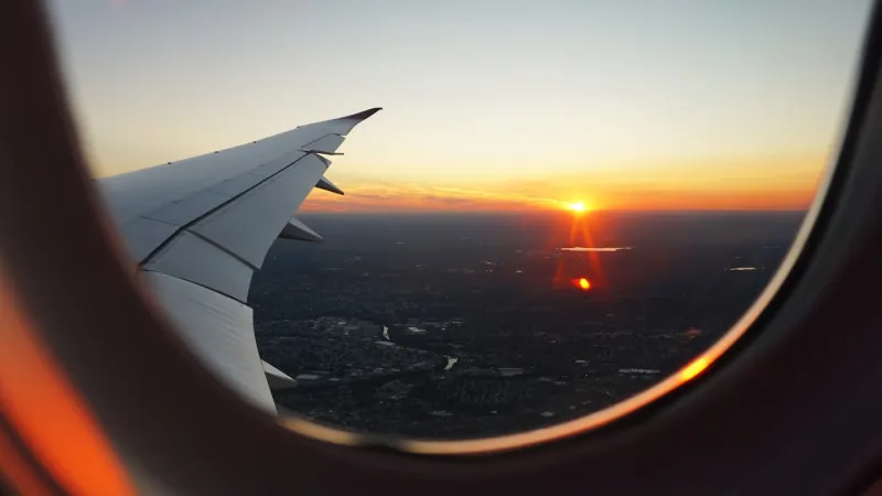 An aircraft wing above clouds at cruising altitude