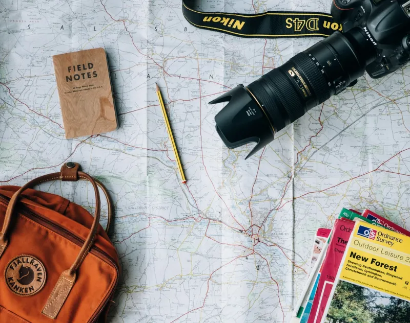 Two travellers with a backpack and map planning a route